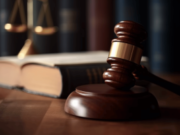 Federal casino fraud indictment targets Sacramento man over fake cannabis investment Wooden judge gavel on courtroom desk with law books and scales representing federal fraud charges and criminal court proceedings. Federal casino fraud indictment targets Sacramento man over fake cannabis investment