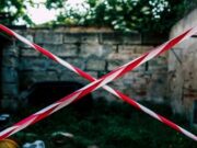 Indonesia blocks Polymarket amid expanding global pressure against prediction market platforms Red and white barrier tape forming an X to block a restricted area.