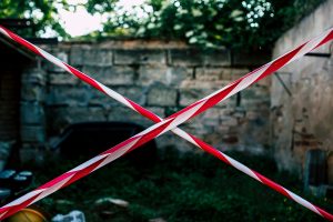 Indonesia blocks Polymarket amid expanding global pressure against prediction market Red and white barrier tape forming an X to block a restricted area.