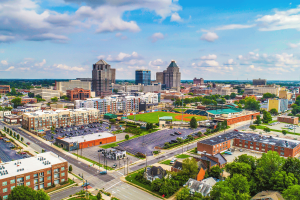 New Lumbee website explains upcoming tribal gaming amendment vote before Aerial view of downtown Greensboro, North Carolina, featuring the city skyline, baseball stadium, commercial buildings, and surrounding neighborhoods. New Lumbee website explains upcoming tribal gaming amendment vote before June