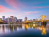 Pennsylvania regulators approve $180K in gaming fines while expanding involuntary exclusion lists Pittsburgh skyline at sunset with illuminated yellow bridges reflecting across the Allegheny River in downtown Pennsylvania. Pennsylvania regulators approve $180K in gaming fines while expanding involuntary exclusion lists