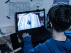 Teen sues Roblox, Fortnite, and Minecraft firms over alleged addictive gaming design Teen playing Roblox-style online video game on laptop wearing headset amid lawsuit concerns over addictive gaming and microtransactions