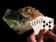 University researchers launch major independent UK gambling harms evidence center Person holding royal flush poker hand beside euro banknotes and luxury watch symbolizing gambling winnings, casino betting, and financial risk. University researchers launch major independent UK gambling harms evidence center