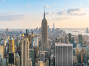New York advances bill requiring monthly sports betting account statements Panoramic view of the New York City skyline featuring the Empire State Building and Lower Manhattan skyscrapers during sunset, highlighting New York's financial and entertainment hub. New York advances bill requiring monthly sports betting account statements
