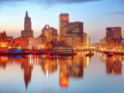 Rhode Island Senate advances bill expanding sports betting competition Rhode Island skyline at sunset reflected on the Providence River, highlighting downtown Providence as lawmakers consider expanding the state's sports betting market and ending its sportsbook monopoly.